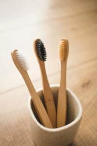 Image of three toothbrushes in a cup